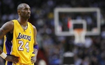 Los Angeles Lakers' Kobe Bryant watches a Miami Heat free throw in their NBA basketball game in Miami, Florida January 19, 2012.