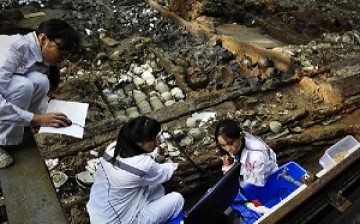 Archaeologists sift through debris in the wrecked ship 
