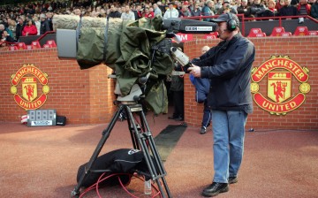 A local cameraman covering a Manchester United game.