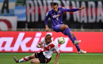 Sanfrecce Hiroshima's Douglas leaps over River Plate's Jonatan Maidana during the semifinals of the 2015 FIFA Club World Cup. The striker is now with Al Ain FC.