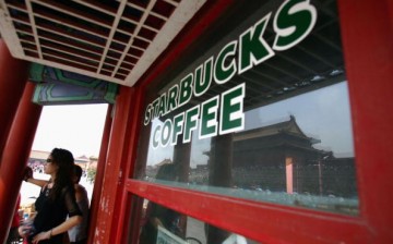 Visitors take a break at Starbucks Coffee at the Forbidden City on Sept. 6, 2005, in Beijing, China.