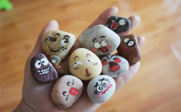 Stones painted with emojis are created by a primary school teacher from Shandong Province, Jan. 17, 2016. 