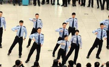 Railway policemen perform at the waiting room of Changchun railway station in Northeast China's Jilin Province on Jan. 24, 2016. The dance is aimed at making passengers happy.