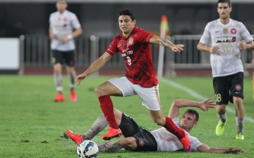 Brazilian striker Elkeson of Guangzhou Evergrande competes the ball with Sam Gallaway of Western Sydney Wanderers during the AFC Asian Champions League match at Tianhe Sports Center in Guangzhou.