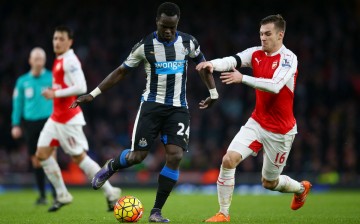 Newcastle United midfielder Cheick Tiote (middle) competes for the ball against Arsenal's Aaron Ramsey.