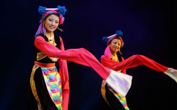 Members of a performance troupe from Sichuan Province perform Tibetan folk dance in Beijing, China, on June 14, 2008.