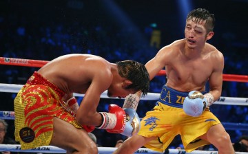 China's Zou Shiming (R) punches Thailand's Kwanpichit Onesongchaigym during their flyweight fight in Macau in November 2014.