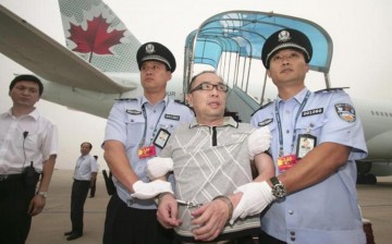 Chinese fugitive Lai Changxing is escorted back to Beijing from Canada, at Beijing International Airport, July 23, 2011. 