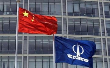 A COSCO company flag and a Chinese national flag fly in front of the company's headquarters in Beijing, Aug. 26, 2010. 