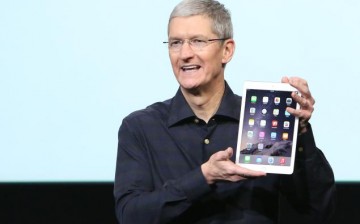 Apple CEO Tim Cook holds an iPad Air 2 during a presentation at Apple headquarters in Cupertino, California October 16, 2014.