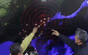 Scientists from the Korea Meteorological Administration point at the screen showing seismic waves near Seoul, South Korea, caused by a North Korean hydrogen bomb test on Jan. 6, 2016. 
