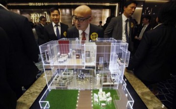 A real estate agent looks at a housing model displayed by a property developer in Hong Kong.