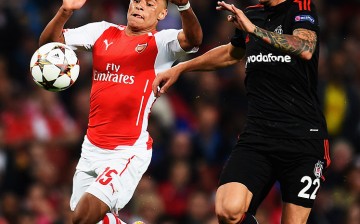 Turkish defender Ersan Gulum (R) competes for the ball against Arsenal's Alex Oxlade-Chamberlain.