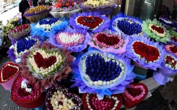 Roses of different colors are seen at a flower market in Kunming, capital of southwest China's Yunnan Province, Feb. 14, 2016.