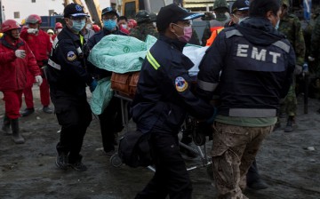 Rescuers carry a victim of the Feb. 6 Taiwan earthquake. China has pledged assistance to the victims of the quake.