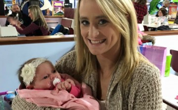 Leah Messer holds a baby at her daughter's birthday party.