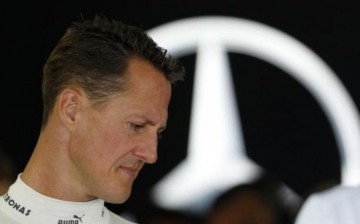 Mercedes Formula One driver Michael Schumacher of Germany stands inside his team garage during the first practice session of the Japanese F1 Grand Prix at the Suzuka circuit Oct. 5, 2012
