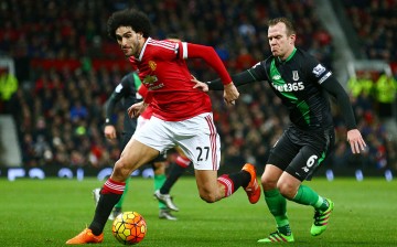 Manchester United midfielder Marouane Fellaini competes for the ball against Stoke City's Glenn Whelan.