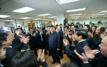 President Xi Jinping meets with the editors and other staff in the newsroom at the headquarters of People's Daily newspaper.