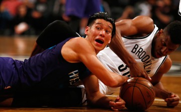 Jeremy Lin (left) and Thaddeus Young of the Brooklyn Nets battle for the ball during their game on Feb. 21 at the Barclays Center.