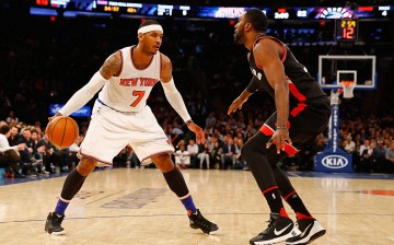 New York Knicks forward Carmelo Anthony (L) makes a move against Toronto Raptors Patrick Patterson.