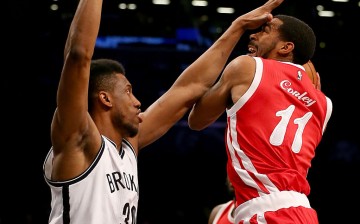 Memphis Grizzlies point guard Mike Conley (R) drives against Brooklyn Nets' Thaddeus Young.
