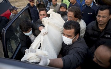 Hospital employees put inside a 4WD victims of the Nepalese plane crash, for transport to the morgue after the rescue team brought the bodies by helicopter from Pokhara in Kathmandu, Nepal, on Feb. 25