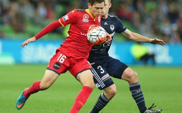 Adelaide United winger Craig Goodwin competes for the ball against a Melbourne Victory defender.