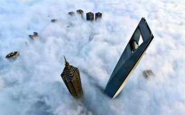 Tops of landmark skyscrapers, including the Oriental Pearl Tower, are seen over cloud sea in Shanghai, east China, Feb. 12, 2016. 