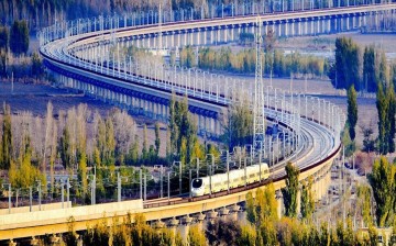 File photo taken on Nov. 3, 2015 shows a bullet train running through a bridge on the Lanzhou-Xinjiang high-speed railway, Northwest China's Xinjiang Uyghur Autonomous Region.