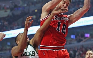 Pau Gasol #16 of the Chicago Bulls rebounds over Jabari Parker #12 of the Milwaukee Bucks at the United Center on March 7, 2016 in Chicago, Illinois. 