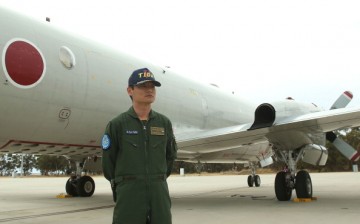 A navy officer of the Japan Maritime Self Defence Force stands in front of a P3 Orion at RAAF base Pearce in Perth, Australia, on April 4, 2014.