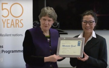 UNDP Administrator Helen Clark gives to a smiling Michelle Yeoh a framed certificate as part of her recent appointment as UNDP Goodwill Ambassador.