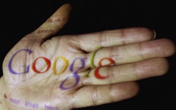 The logo of the multi-facetted internet giant Google is seen projected onto the palm of a hand.