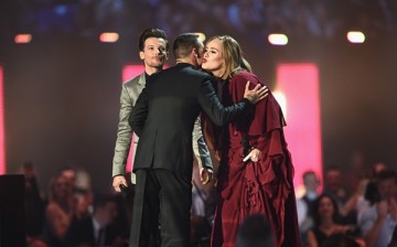 Adele receives her Best British Female Solo Artist award on stage from presenters Liam Payne and Louis Tomlinson at the BRIT Awards 2016 in London, England. 
