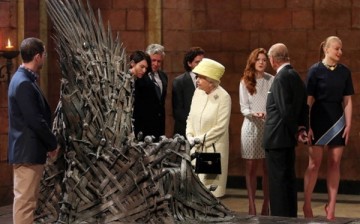 Queen Elizabeth II meets 'Game of Thrones' stars Lena Headey and Conleth Hill while Prince Philip, Duke of Edinburgh shakes hands with Rose Leslie as they view the Iron Throne on set in Belfast, Northern Ireland. 