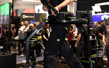 Jeremy Gaddis uses the Virtuix Omni, an omni-directional treadmill virtual reality gaming system with Oculus Rift.