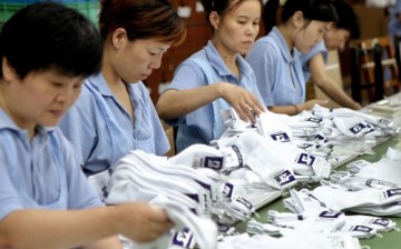 Workers prepare socks at a facility in Shanghai. China's manufacturing sector is being hit hard by the country's aging population.