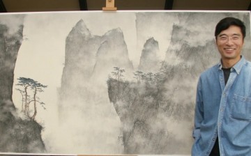 Behind every great artist is a great piece of art, in the literal sense of the word, as shown in the picture: Li Huayi posing with one of his creations.