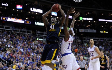 Devin Williams goes strong to the basket against Kansas