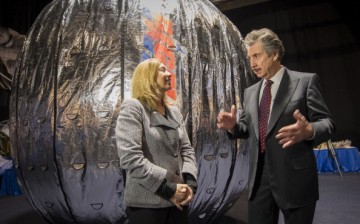 NASA Deputy Administrator Lori Garver and President and founder of Bigelow Aerospace Robert T. Bigelow talk while standing next to the Bigelow Expandable Activity Module (BEAM) during a media briefing.