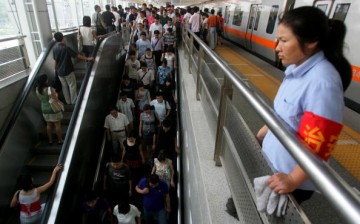A subway staff member keeps watch at the Zhichunlu Station on the Subway Line 10 in Beijing, China, July 21, 2008.