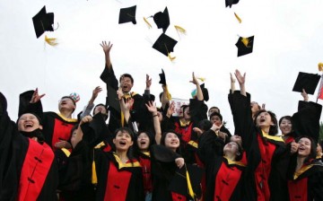 Graduates throw their caps during the graduation ceremony at Shanghai Jiaotong University in Shanghai, China, on June 20, 2005.