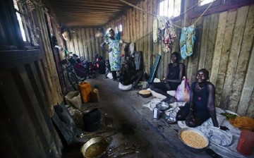 Grains of hope: China gives rice to South Sudan. (Above) Displaced women and children gather inside a container in a compound in Bentiu.