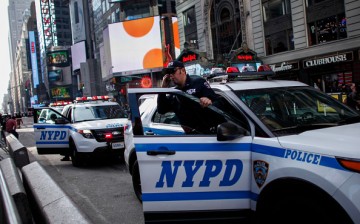 A New York City police exits from a car in Times Square on November 26, 2015 in New York City.   