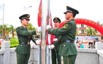 Soldiers raise the Chinese national flag in Sansha City in Xisha Islands.