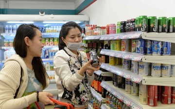 People shop at Xuzhen Supermarket on April 13, 2016 in Shanghai, China. All goods in the supermarket are empty, but the price is the same as usual. 