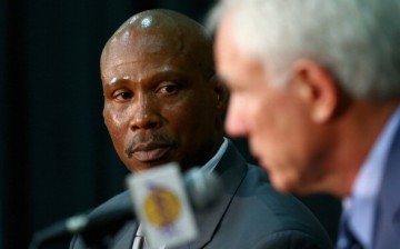 Byron Scott looks on, as Los Angeles Lakers general manager Mitch Kupchak addresses the media. 