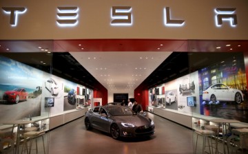 People look at a Tesla Motors vehicle on the showroom floor at the Dadeland Mall on February 19, 2014 in Miami, Florida.   