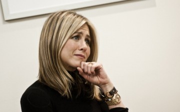 Jennifer Aniston listens to a discussion during a visit to the Breast Care Center at the Inova Alexandria Hospital.   